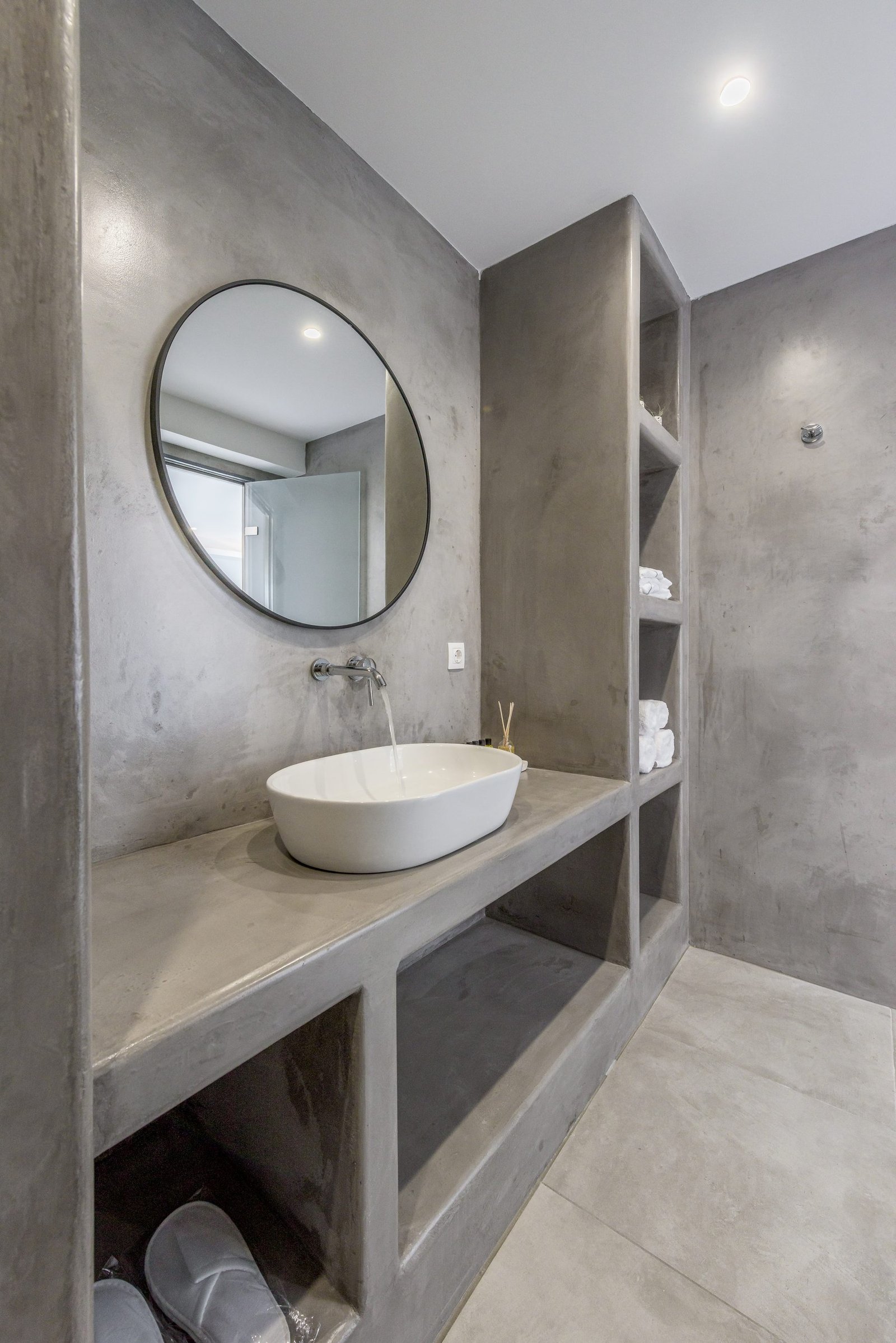 The concrete walk-in shower and spa-style bathroom